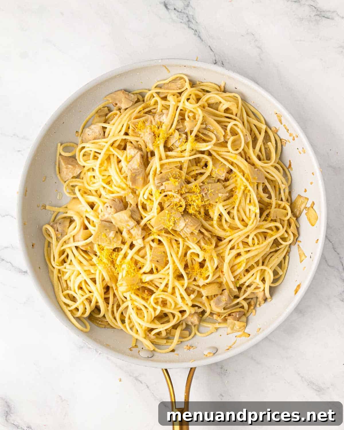 Lemon Artichoke Pasta with Garlic, Parmesan and Herbs 9 A white skillet lemon artichoke pasta.